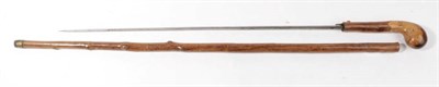 Lot 239 - A Victorian Swordstick, the 53.5cm diamond section steel blade etched with scrolling foliage,...