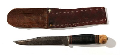 Lot 262 - A Second World War RAF Servicing Commando Knife, 15cm clip point steel blade stamped with broad...