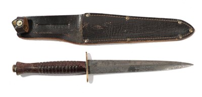 Lot 265 - A Second World War Commando Knife, the 17cm double edge leaf shape machine forged steel blade...