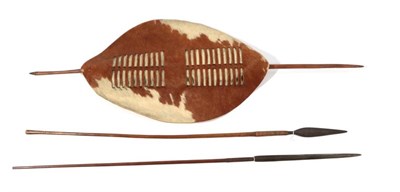 Lot 296 - A Zulu Cow Hide Shield, of elliptical form, with central double band of slits which secure the wood