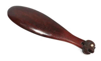 Lot 318 - A Late 19th Century Maori Patu, in dense mahogany coloured wood, the pommel carved as a head...