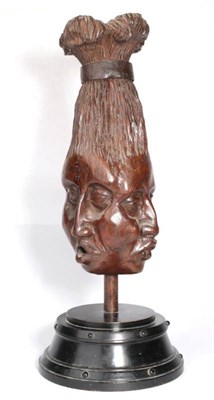 Lot 320 - A Carved Oak Post Finial, carved as a tribal head with three different faces, the upswept...