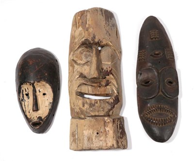 Lot 325 - A Carved Wood Mask, possibly North American Indian, of light wood with remnants of gold paint, tall