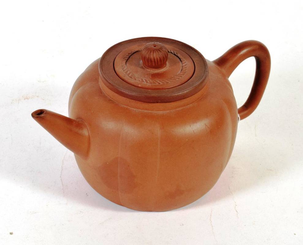 Lot 25 - A Chinese Yixing redware teapot, melon fluted, with cover and strainer