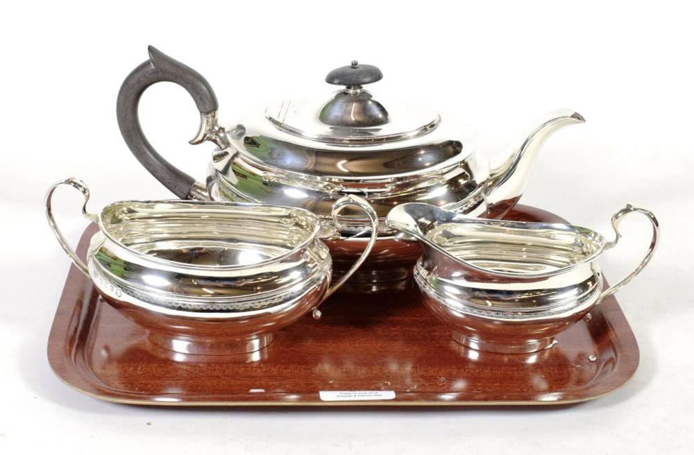 Lot 31 - A three piece silver tea service, Viners Ltd, Sheffield 1952/55, oval, with a band of engraved...