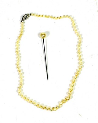Lot 69 - A graduated cultured pearl necklace, length 42cm; and a simulated pearl stick pin