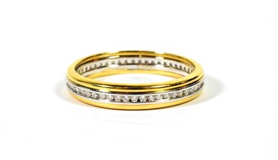 Lot 93 - An 18 carat two colour gold channel set diamond eternity ring, total estimated diamond weight...