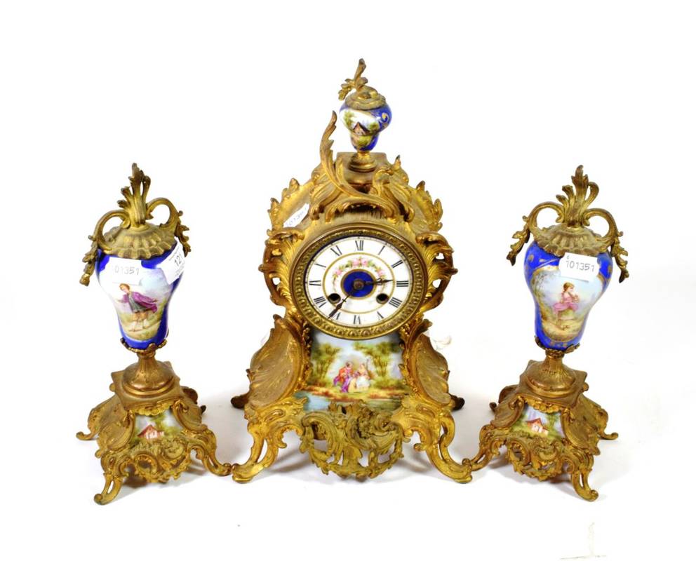 Lot 121 - A gilt metal and porcelain mounted striking clock garniture circa 1900