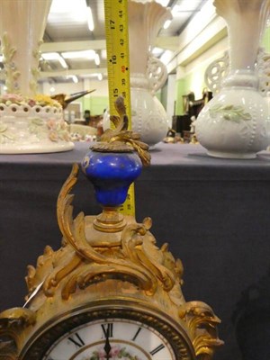 Lot 121 - A gilt metal and porcelain mounted striking clock garniture circa 1900