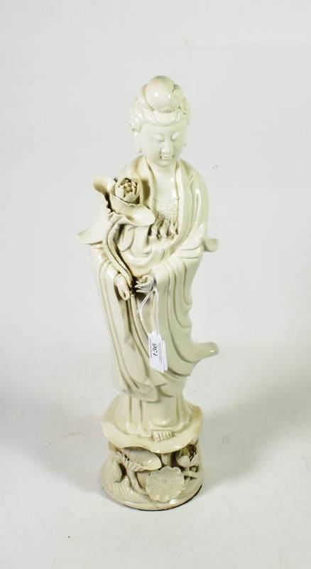 Lot 136 - A Chinese blanc de chine figure of Guanyin, Qing Dynasty, standing wearing flowing robes...