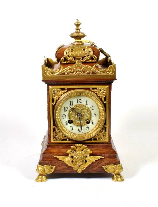 Lot 141 - An oak and gilt metal mounted striking mantel clock, circa 1910, twin barrel movement striking on a