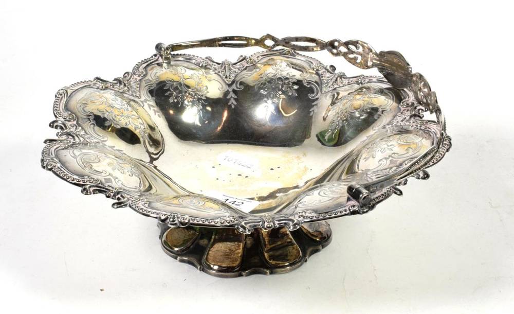 Lot 142 - A Victorian silver swing handled footed basket