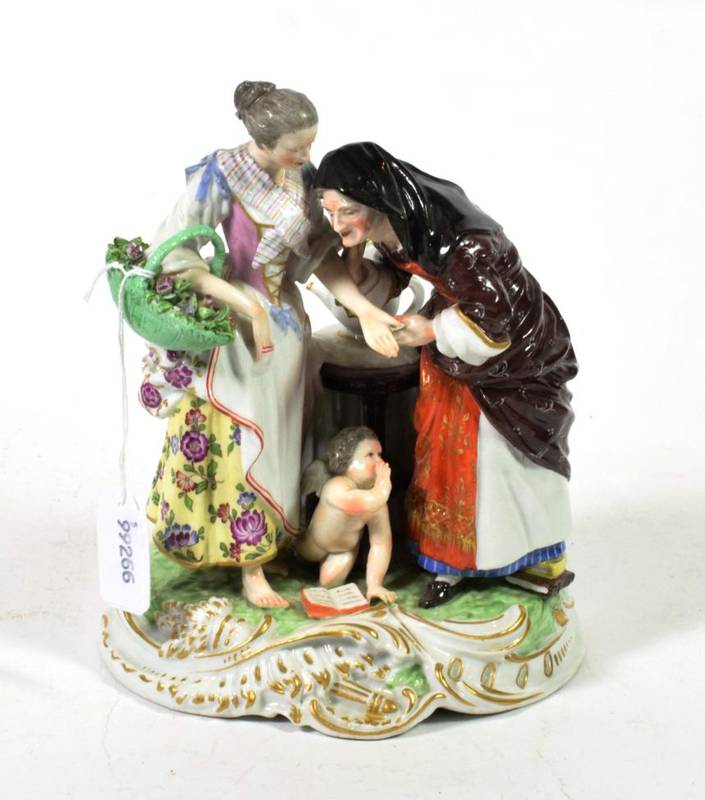 Lot 146 - A Samson Derby figural group, 19th century, modelled as an elderly fortune teller reading the...