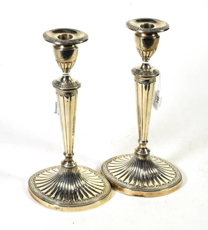 Lot 148 - A pair of late Victorian silver candlesticks of George III style, Thomas Bradbury & Sons,...