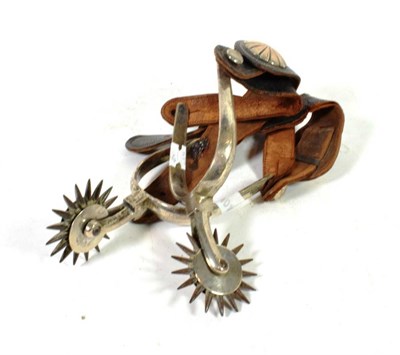 Lot 201 - A pair of white metal spurs