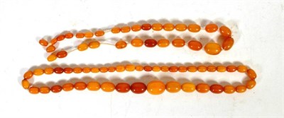 Lot 241 - An amber bead necklace, length 56cm; and an unstrung amber bead necklace