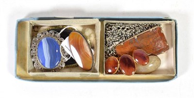 Lot 264 - Six hardstone brooches; together with three white metal chains, marks rubbed