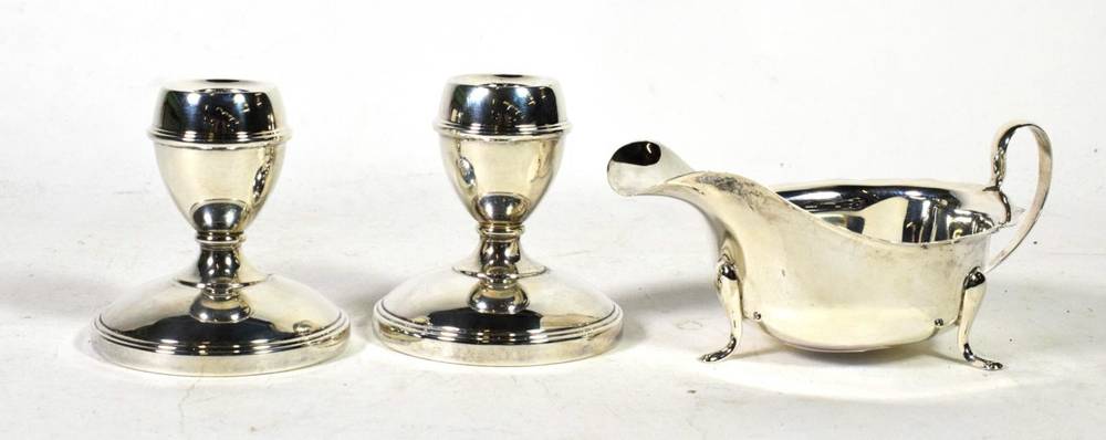 Lot 274 - A pair of dwarf silver candlesticks, J B Chatterley & Sons, Birmingham 1963; and a silver sauce...