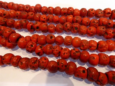 Lot 315 - A tin of butterscotch coloured bakelite beads, coral beads and other costume jewellery