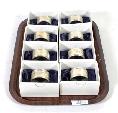 Lot 353 - Eight modern silver heavy gauge napkin rings, J A Campbell, London 1997, engraved with the...