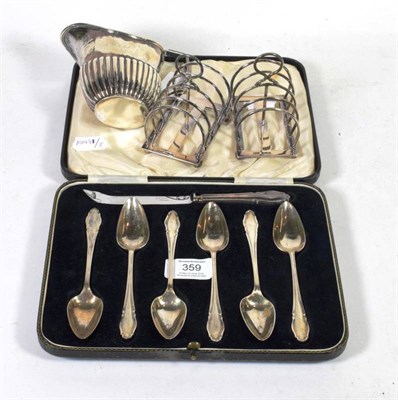 Lot 359 - A pair of silver toast racks, Ollivant & Botsford, Sheffield 1910; a Victorian cream jug,...