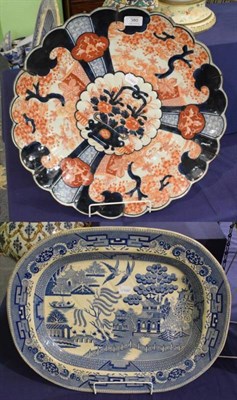 Lot 380 - An Imari charger; and a Willow pattern meat plate