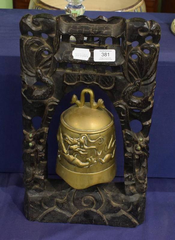 Lot 381 - A Chinese bronze temple bell on carved wooden stand
