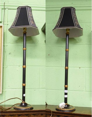 Lot 384 - A pair of modern black and gilt faux bamboo table lamps in the aesthetic taste