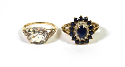 Lot 388 - A sapphire and diamond cluster ring, stamped '9K', finger size P; a clear stone ring, stamped '375'