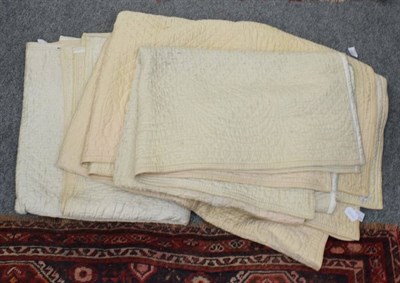 Lot 1090 - Pair of early 20th century north country cream whole cloth single quilts, reversible, with...