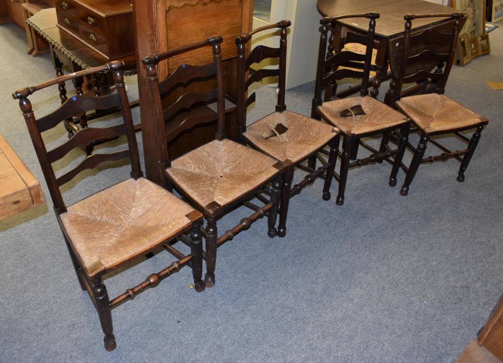 Lot 1139 - A set of five ladder back rush seated chairs