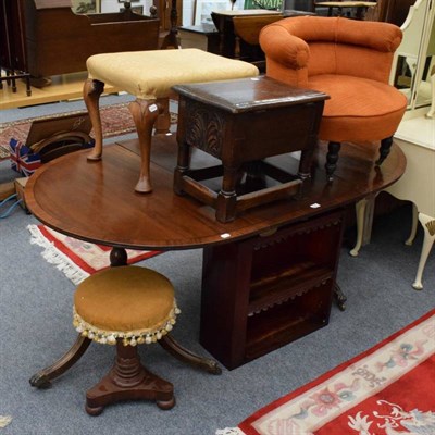 Lot 1145 - Group of furniture comprising a pedestal dining table; two tier bookcase; adjustable piano...