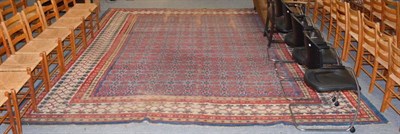 Lot 1168 - An Amristar Indian carpet, the shaded indigo field with an allover design of flowerheads...