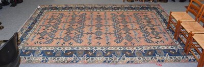 Lot 1169 - Dosemealti rug, the pale terracotta field of latch hook motifs enclosed by indigo borders, 378cm by