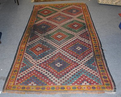 Lot 1172 - A South East Iranian summer rug, the stepped diamond lattice field enclosed by mustard borders,...
