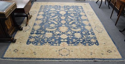 Lot 1174 - An Afghan Ziegler design carpet, the shaded indigo field with serrated leaves and flower heads...