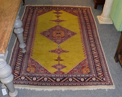 Lot 1175 - A Fereghan design rug, the lemon field centred by a stepped diamond medallion, enclosed by serrated