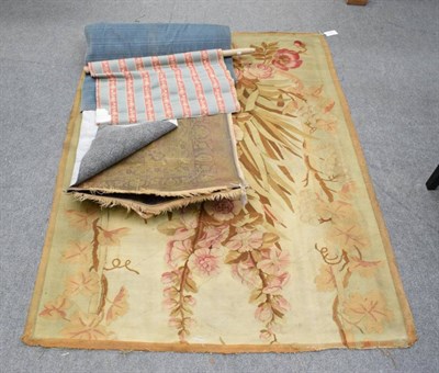 Lot 1187 - A 19th century Aubusson rug fragment, the ivory field with naturalistic flowers, flanked by fluting