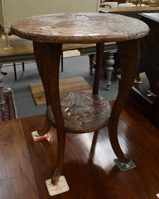 Lot 1218 - An early 20th century French carved occasional table, foliate design, two tiers