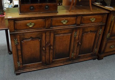 Lot 1226 - Oak dresser base, fitted with three drawers about three cupboard doors, possibly Titchmarsh &...