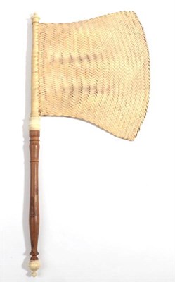 Lot 2056 - A Shaped Woven Flag Fan, with a turned wood handle and bone or ivory for the finial ends and...