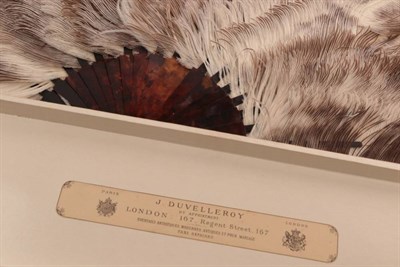Lot 2058 - A Circa 1900 Female Ostrich Feather Fan, the feathers mottled in brown and soft cream, mounted...