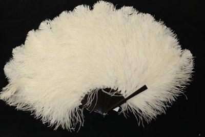 Lot 2059 - A Circa 1900 White Ostrich Feather Fan, the frothy feathers mounted on a dark tortoiseshell...