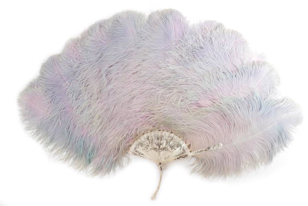 Lot 2061 - A Fine and Large Ostrich Feather Fan, circa 1900, in muted pastel shades of pink/mauve and...