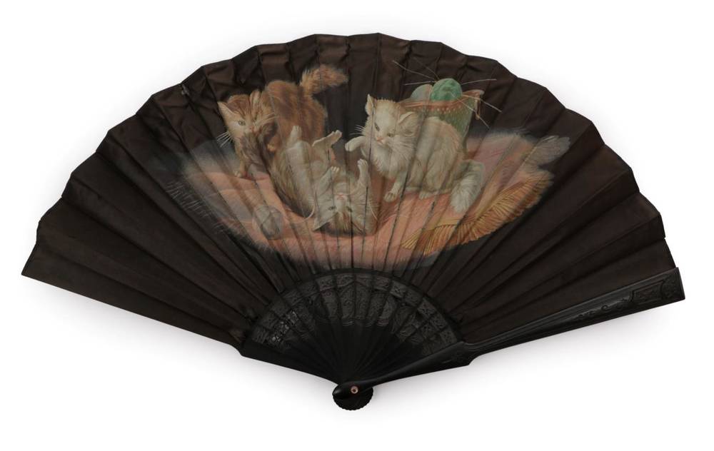 Lot 2143 - Playtime! A Late 19th Century Black Silk Fan, the monture of carved and pierced black wood, the...