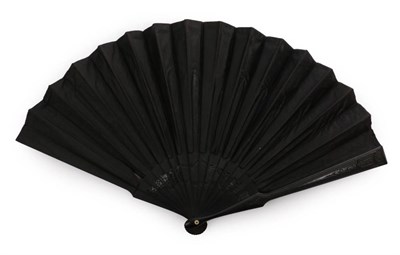 Lot 2143 - Playtime! A Late 19th Century Black Silk Fan, the monture of carved and pierced black wood, the...