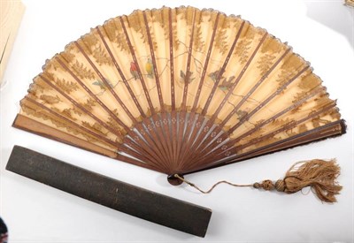 Lot 2146 - A Circa 1890's Fan, with wooden sticks engraved and gilded, the leaf of pale ginger gauze...