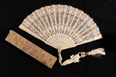 Lot 2151 - An Early 20th Century Maltese Lace Fan, the cream silk leaf mounted on carved and silvered...