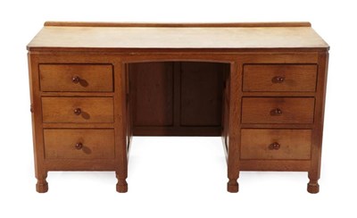 Lot 557 - Mouseman: A Robert Thompson of Kilburn Panelled English Oak Kneehole Desk, with raised upstand,...