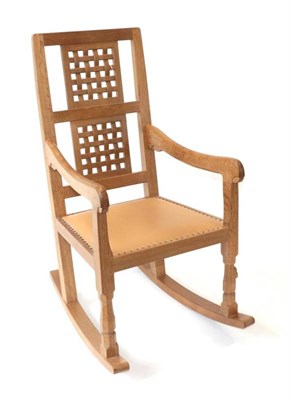 Lot 581 - Mouseman: A Robert Thompson of Kilburn English Oak Rocking Chair, with two lattice panel backs,...